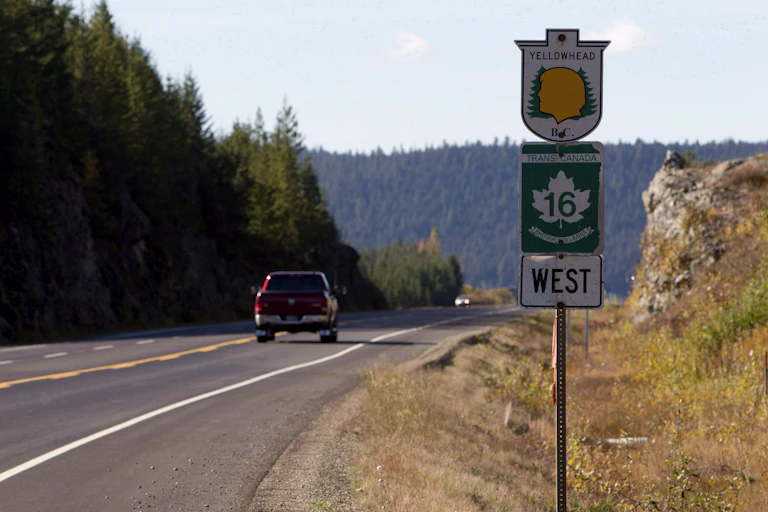 A sign next to a highway that reads: Yellowhead, Trans Canada 16 West