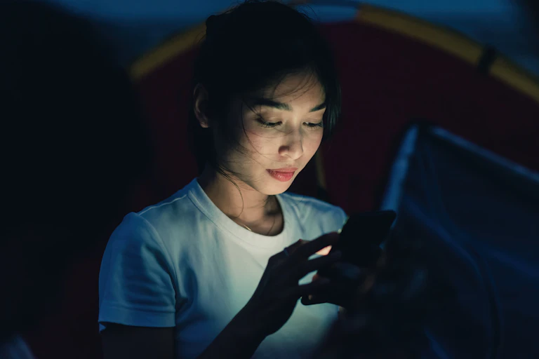 Young Asian woman looking at her phone