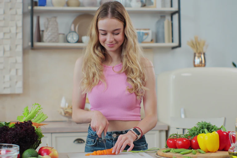 Woman cuts carrot