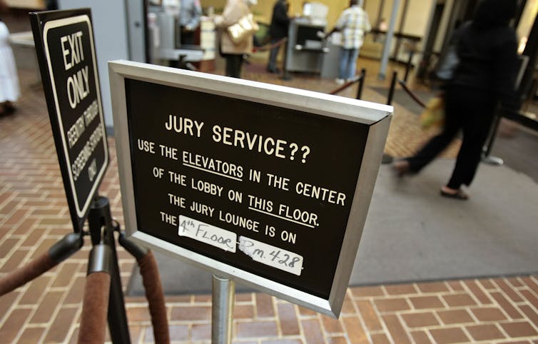 sign directing juror where to report for their service