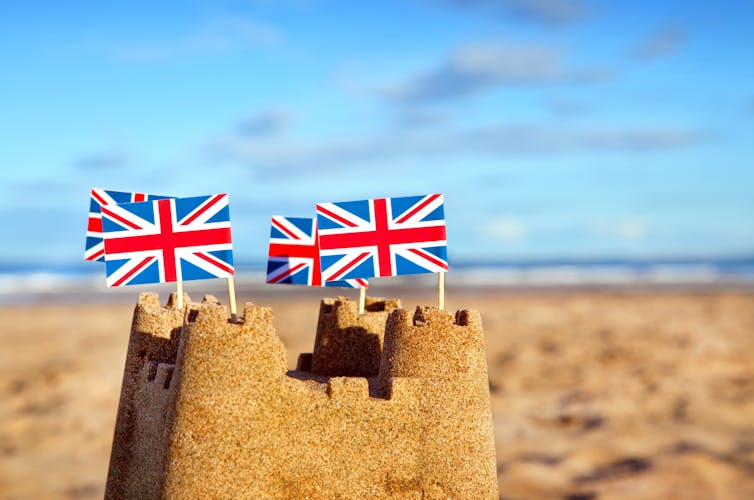 A sandcastle with the union flag in each turret