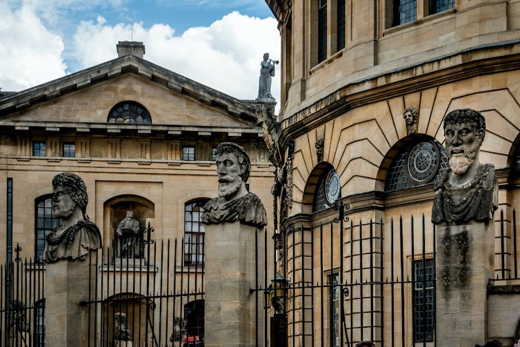 The Sheldonian Theatre in Oxford, featuring stone emperors' heads.