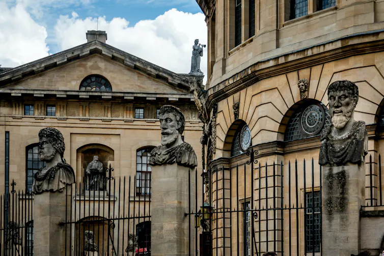 The Sheldonian Theatre in Oxford, featuring stone emperors' heads.