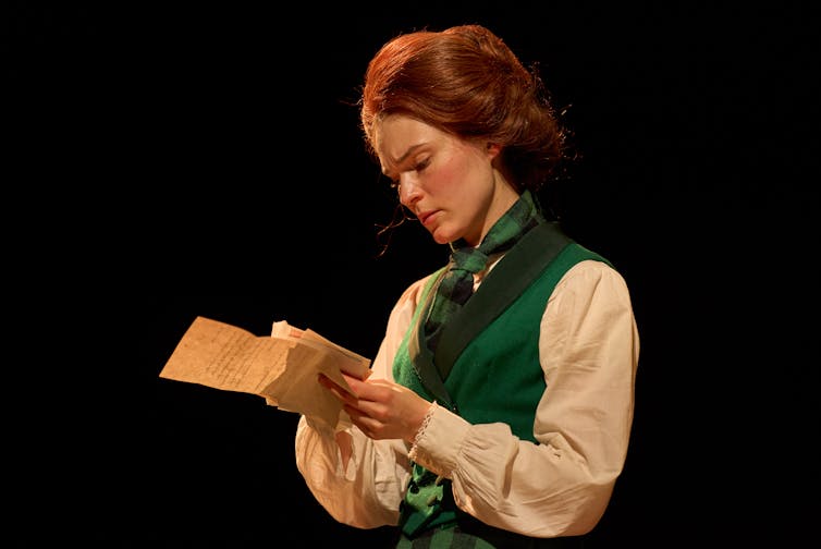A woman reads a letter