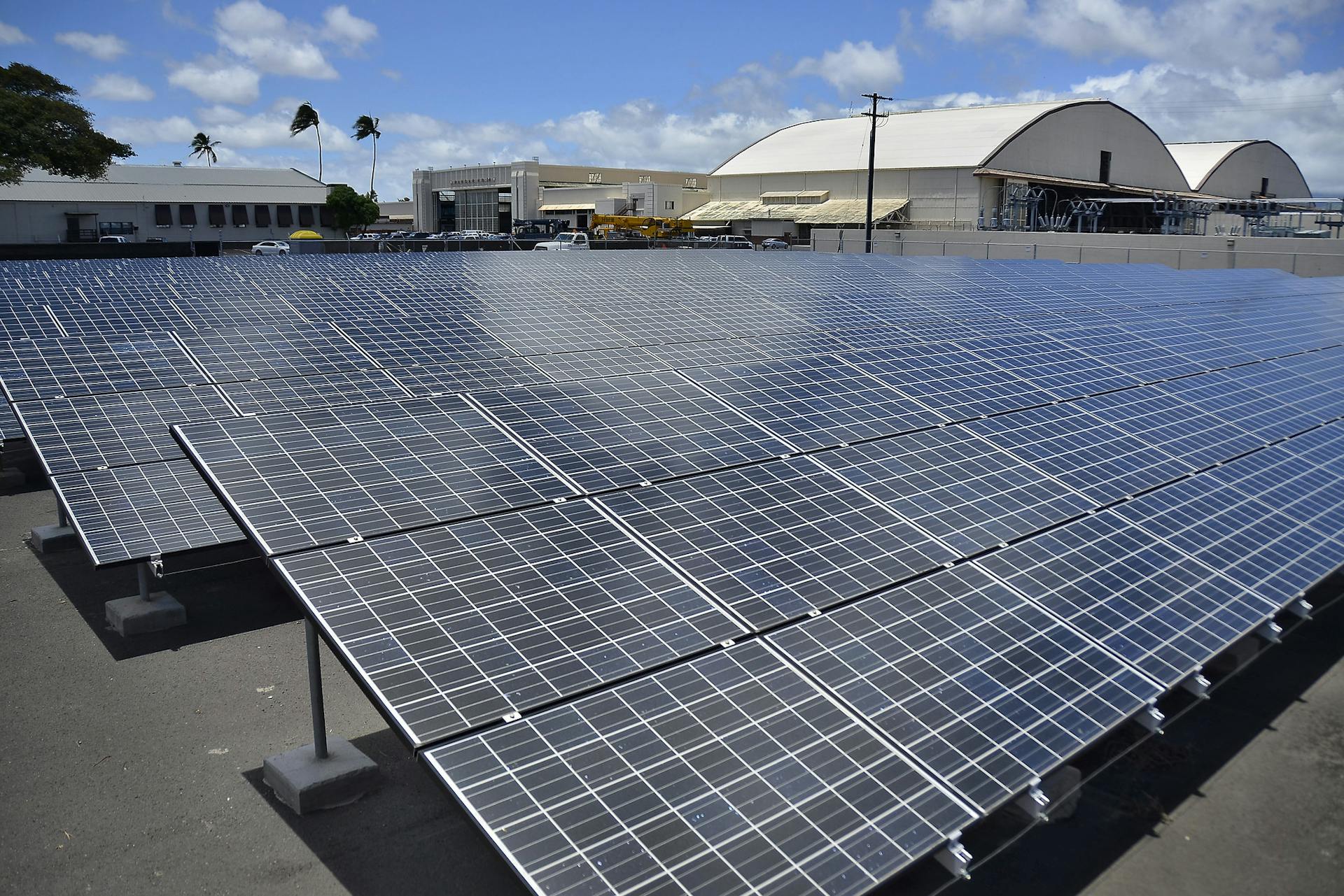 Solar panels outside a military airplane hangar.