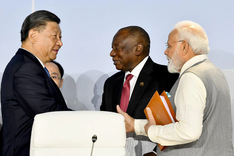 China's leader Xi Jinping at the 2023 Brics meeting, shaking hands with other leaders.