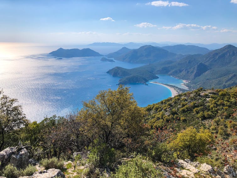 hilly landscape descending toward blue inlet