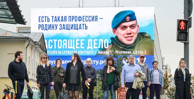 A billboard in Moscow reads: 'There is such a profession to defend the Fatherland'