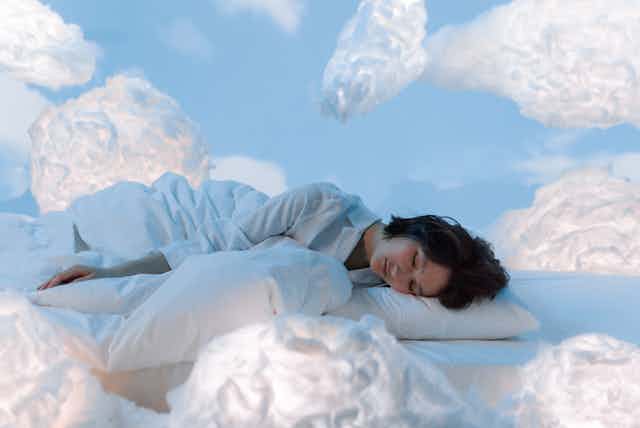 woman asleep surrounded by clouds