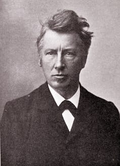 black and white head shot of man in early 20th C attire