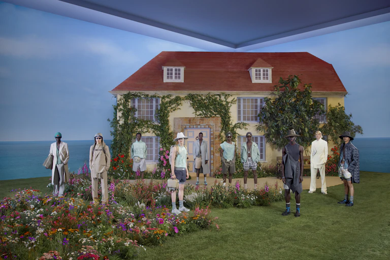 models in front of a reconstruction of Charleston House