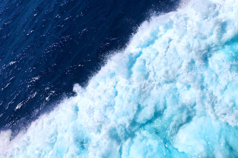 Wave of blue water during daytime.