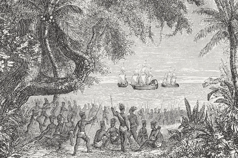 A black and white drawing shows a large crowd of Native American people wearing little clothing and holding spears, looking at boats in the water ahead of them.