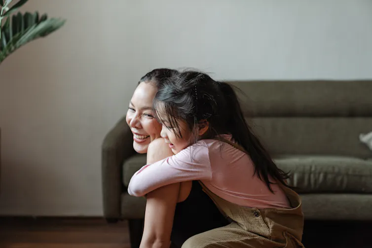 A child hugs her mother.