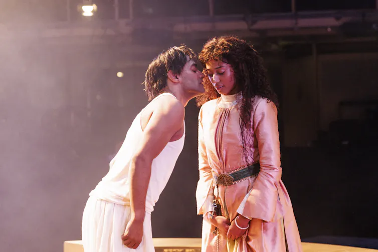 Esh Alladi as Pipli and Cecilia Appiah as Estella. Pipli kisses her on the cheek.