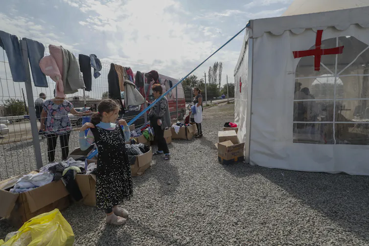 Clothes hand out on a makeshift washing line outside a tent at a refugee camp