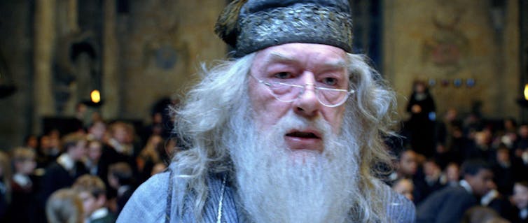An old man wizard, Albus Dumbldore, with a long grey beard and lined face.