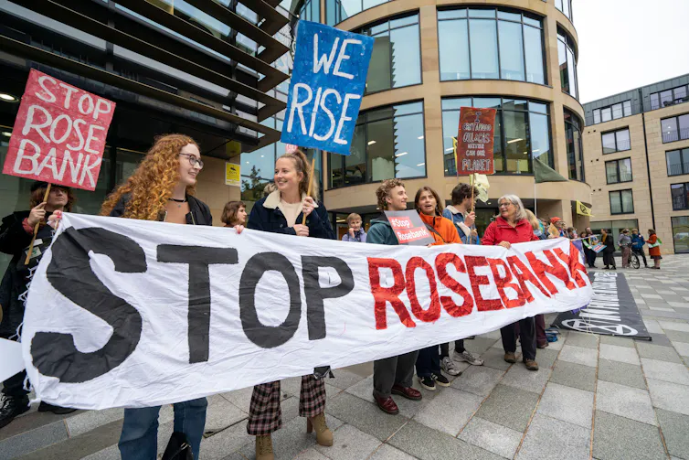 People with 'stop rosebank' banner