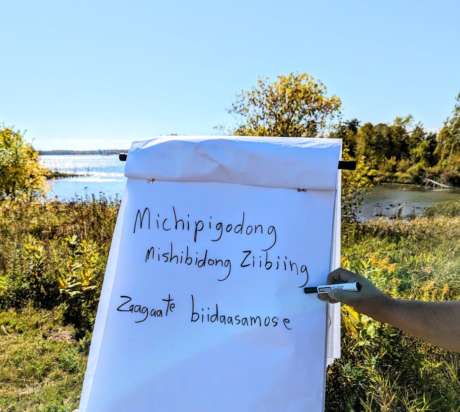 Traditional language written on paper and a river in the background.