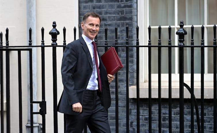 Jeremy Hunt walking along Downing Street, London.