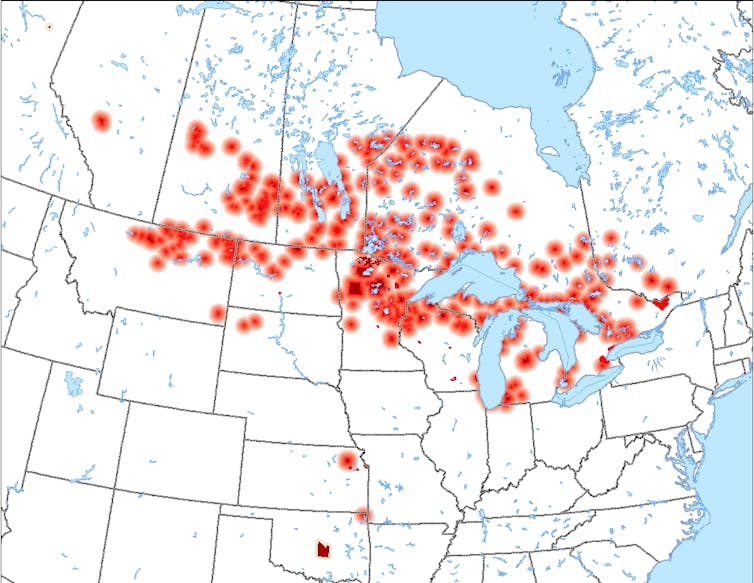 A map of the United States and Canada, with red dots clustered around the Great Lakes.