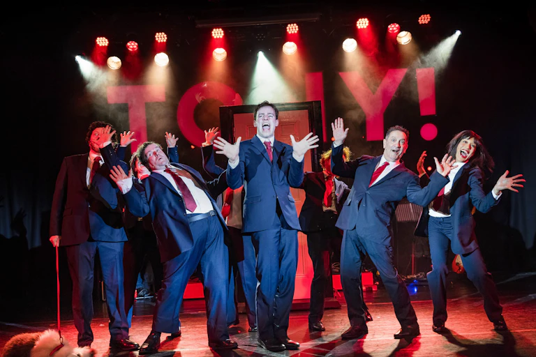 Performers in suits during Tony the Rock Opera