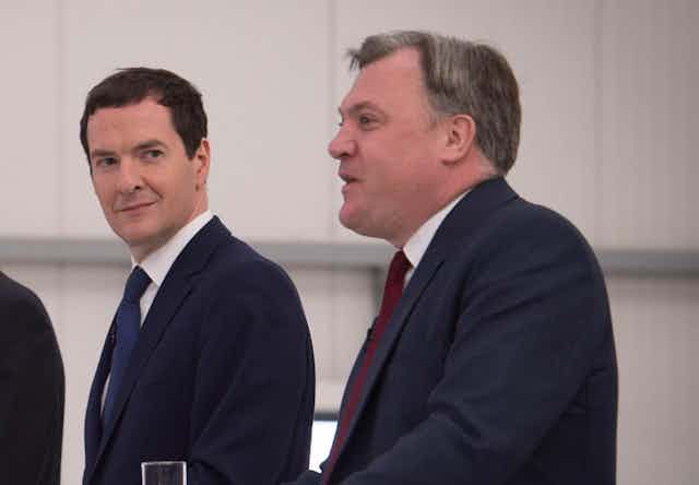 George Osborne and Ed Balls giving a press conference. 