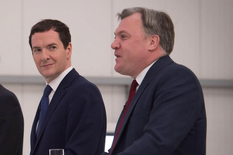 George Osborne and Ed Balls giving a press conference.