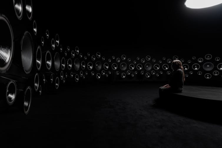 A black room with many speakers.