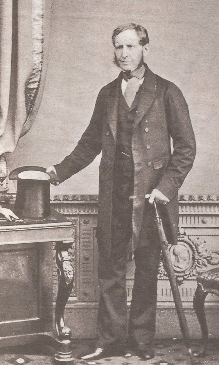 An old black and white photo of a man in a tailcoat