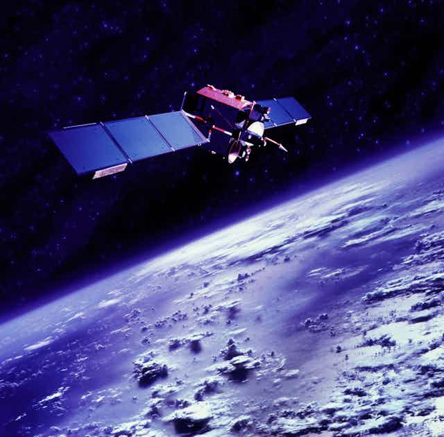 A satellite floats <a href=