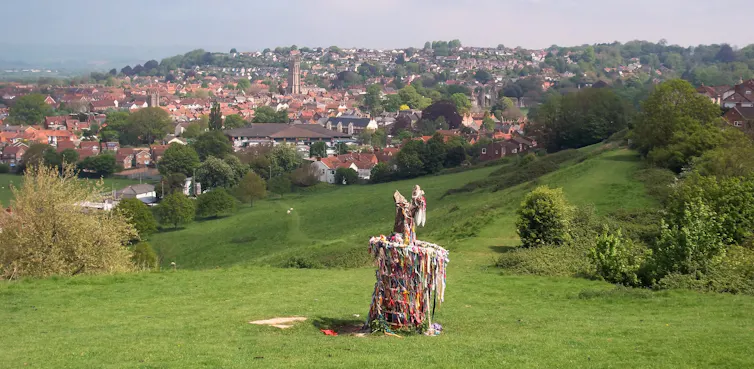 A tree stump surrounded by ribbons.