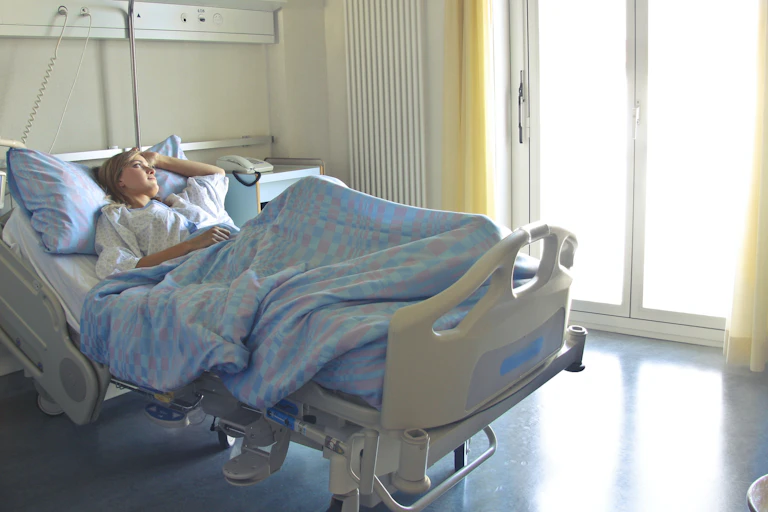 Woman lays in hospital bed