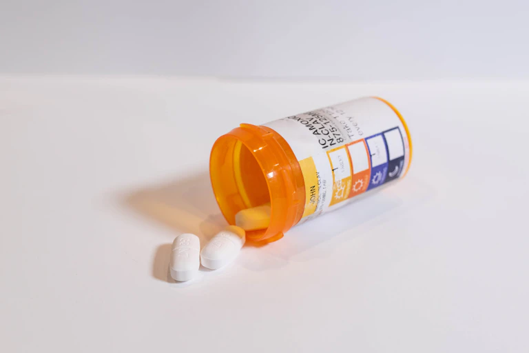 Antibiotics spilling out of a bottle