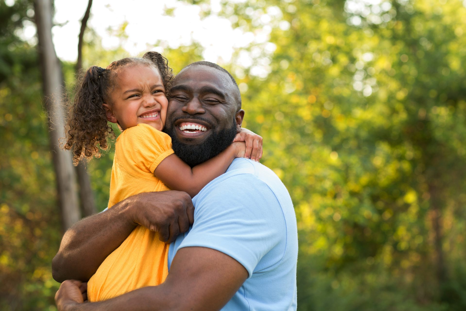 Father hugging happy daughter