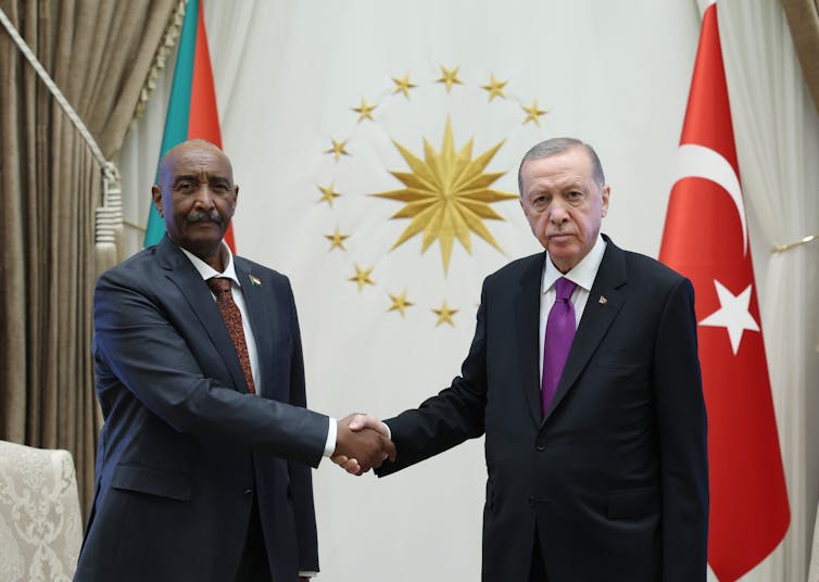 Gen. Abdel Al-Burhan and President Recep Tayyip Erdogan shake hands