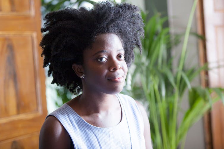 Portrait of young Black woman bathed in sunlight.