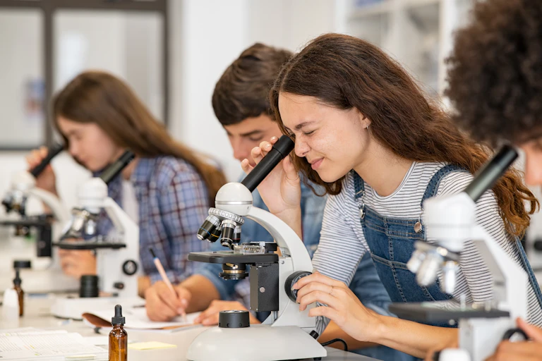 Students looking through microscopes