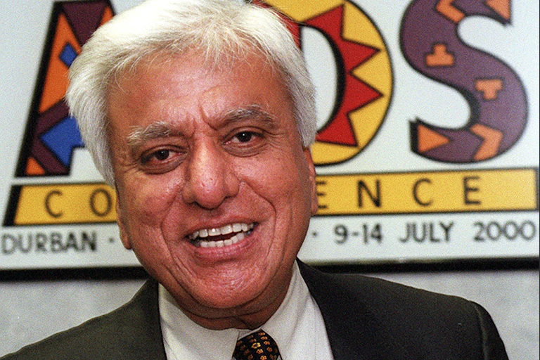 A white-haired smiling man.