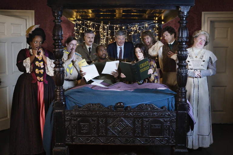 The cast of ghosts gathered round a bed