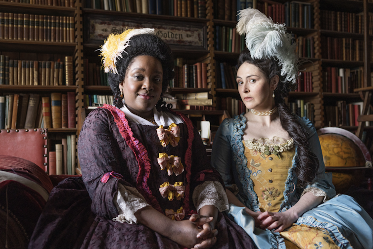 ghosts british tv Two women in Georgian dresses.