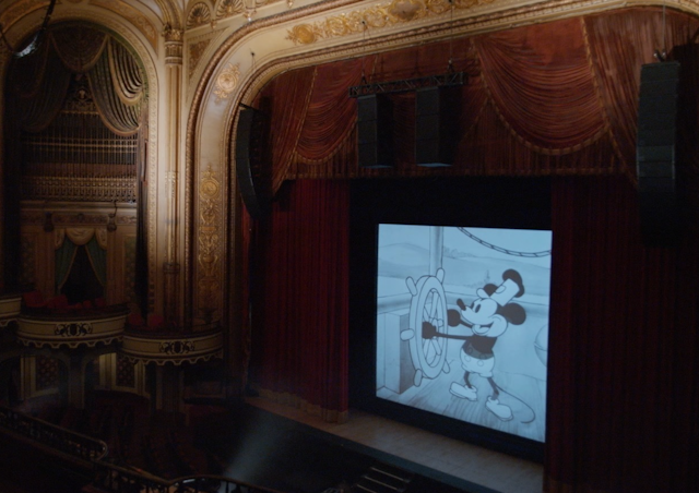 Steamboat Willie playing on a cinema screen.