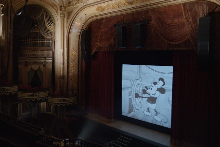 Steamboat Willie playing on a cinema screen.