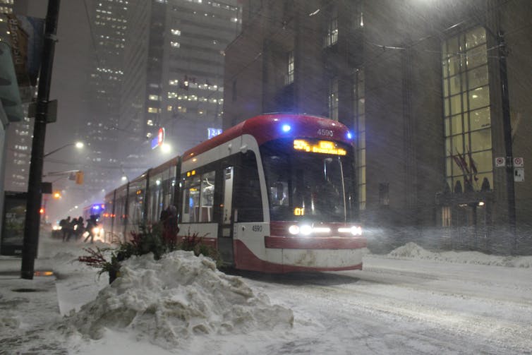 A Toronto streetcar seen on a snowy night.