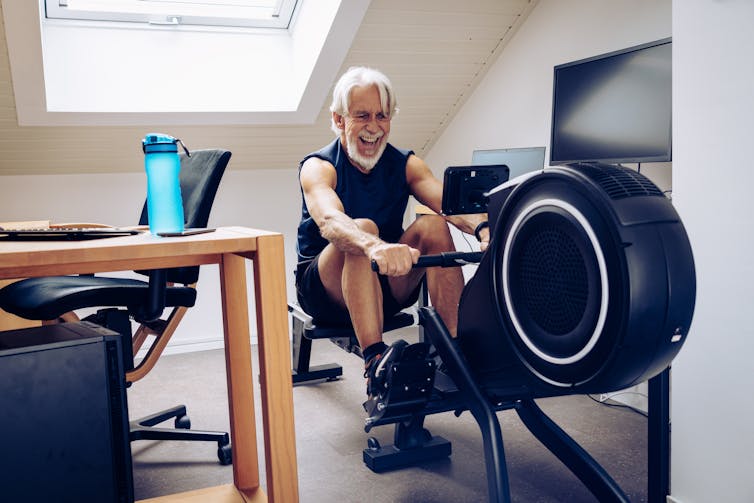 A man on a rowing machine at home.