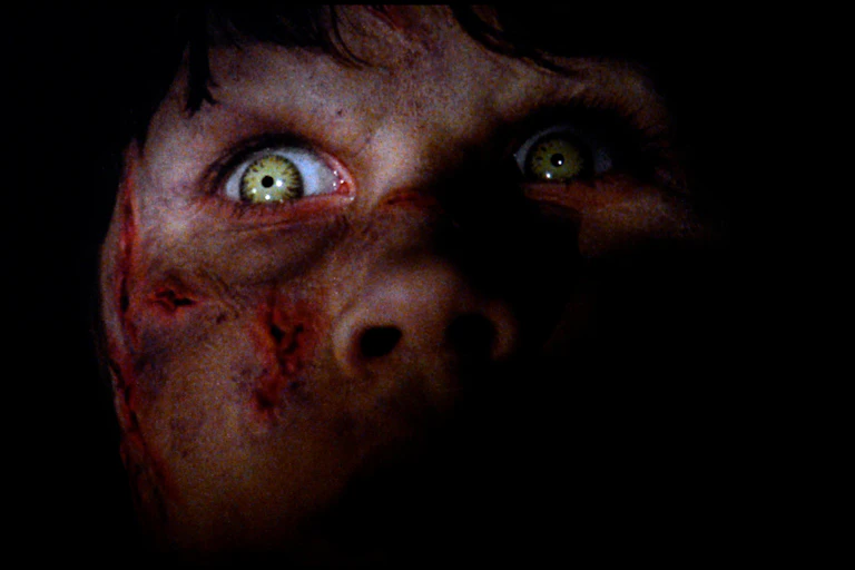 A young girl with green eyes who is possessed by the Devil.