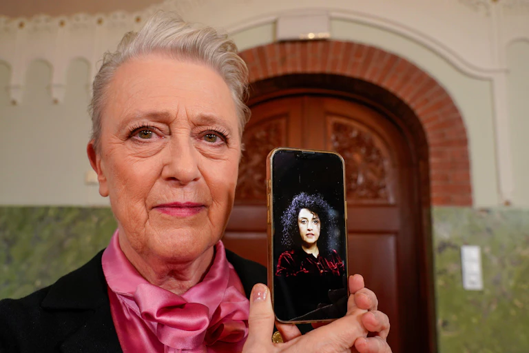 Nobel committee chair Berit Reiss-Andersen holds up a phone with a picture of 2023 Nobel peace prize winner Narges Mohammadi.