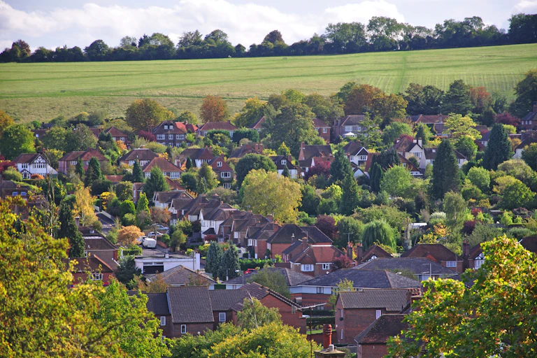 Houses near a green field.