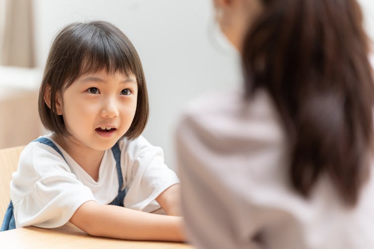 Small girl and mother talking