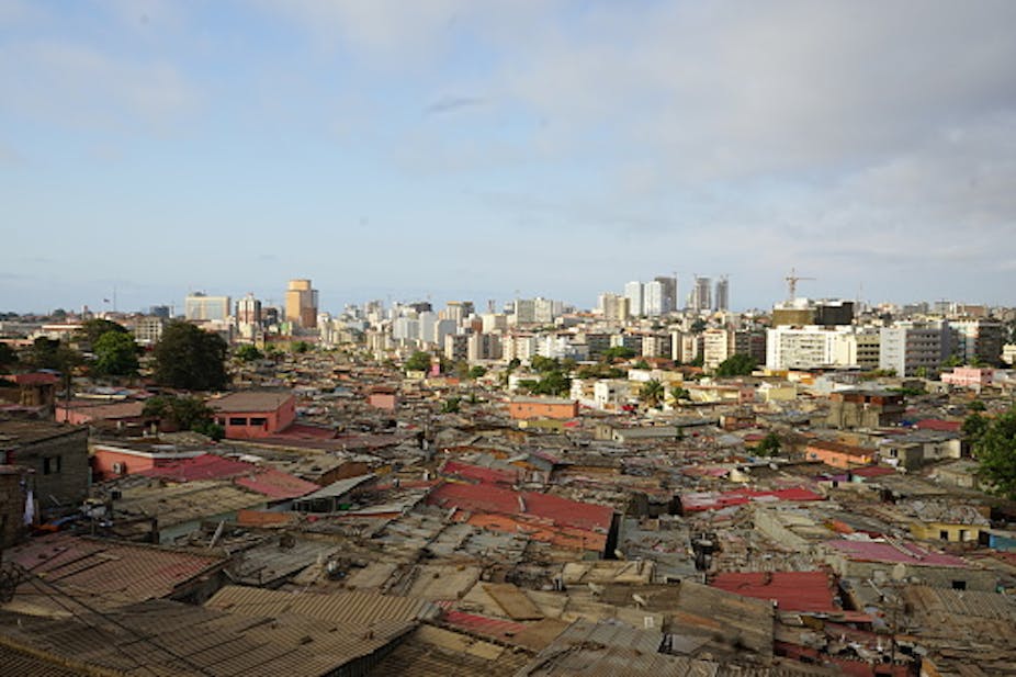 View of urban landscape with high-rise buildings and densely packed low-rise structures.